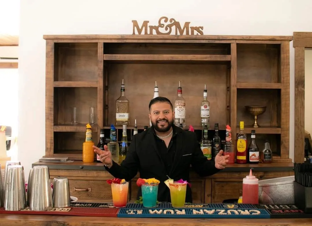 Bartender serving signature drinks at the indoor bar of Primrose Hill wedding venue