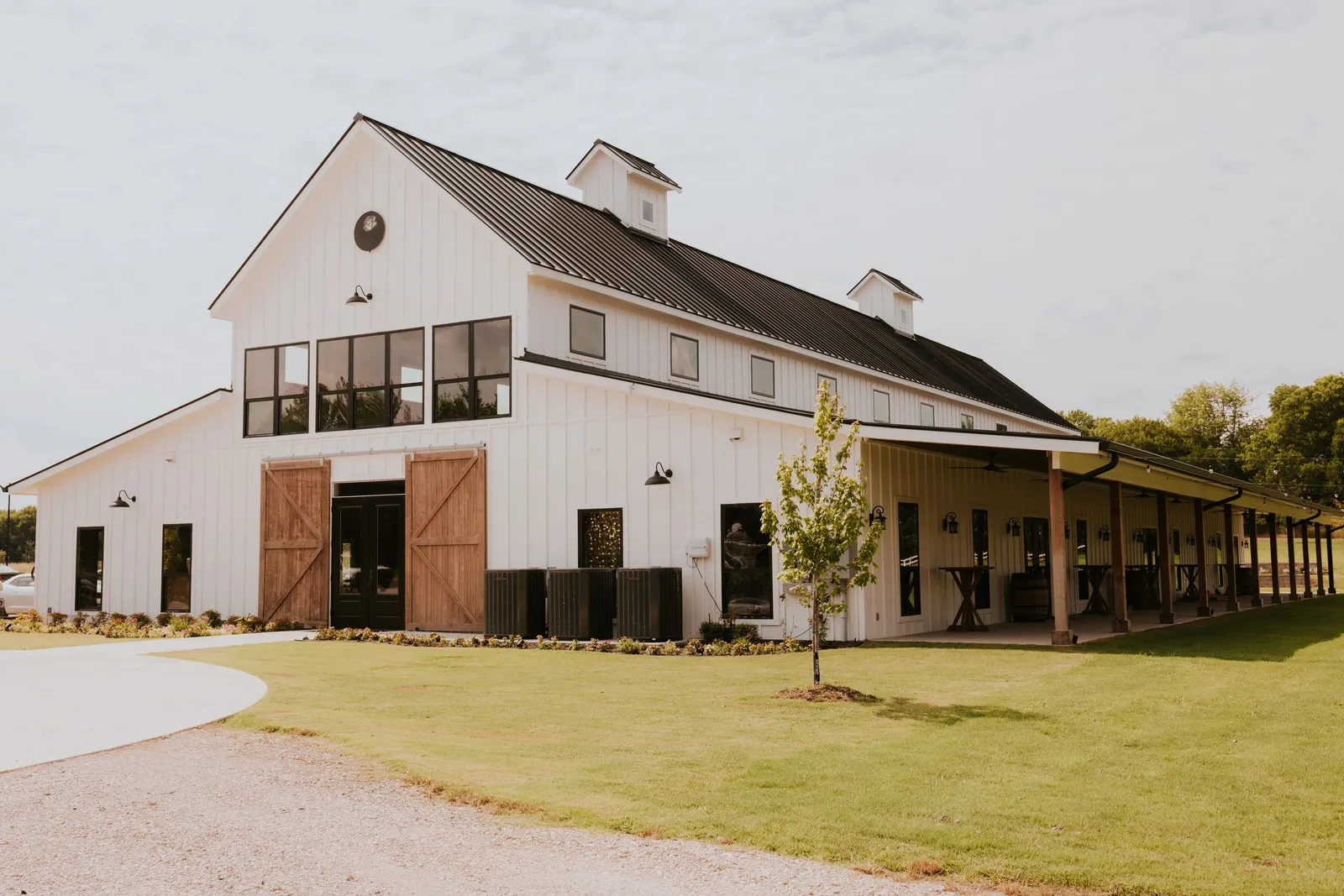 Included rustic cross-back chairs and tables at the wedding venue